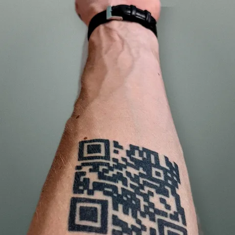 Founder forearm with a real QR code tattoo